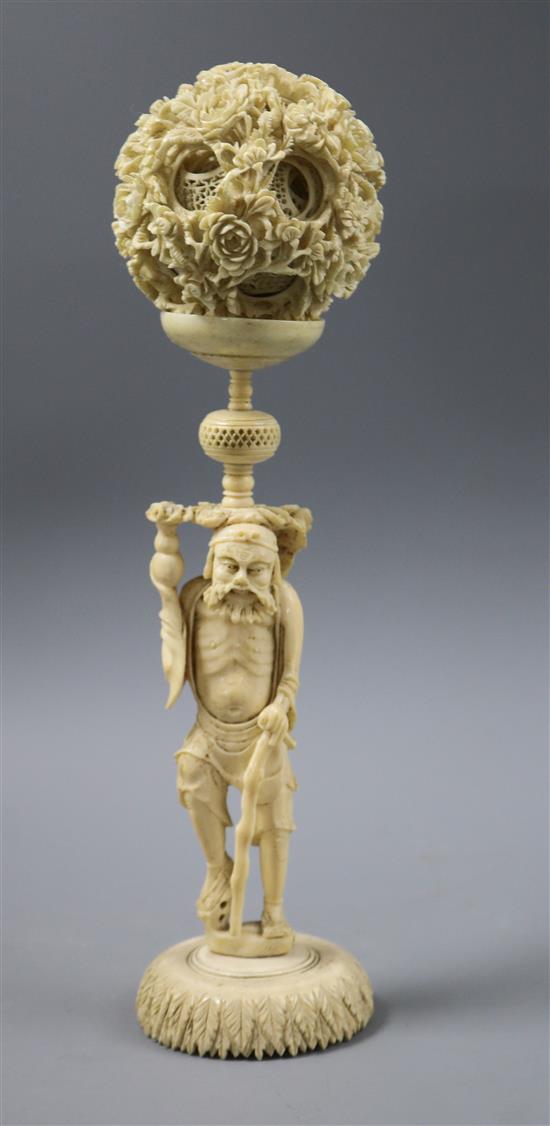 A Chinese ivory concentric ball on figural stand